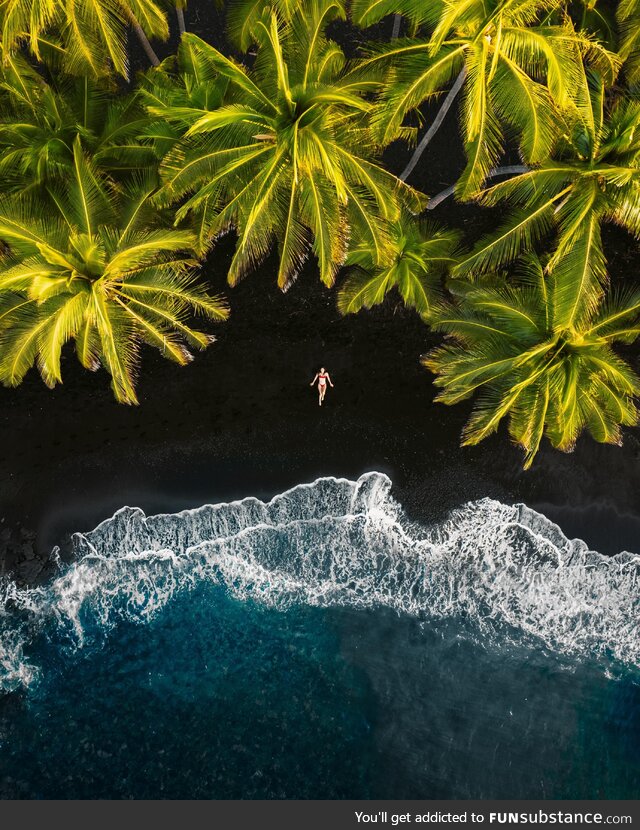 A black sand beach. Made from lava exploding as it cools from reaching the ocean