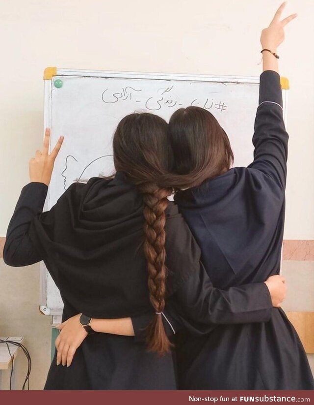 Two Iranian student girls celebrating the International Girls day