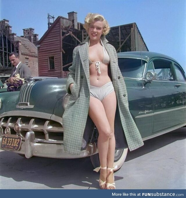 Marilyn Monroe poses for a portrait next to a 1950 Pontiac Chieftain in 1951