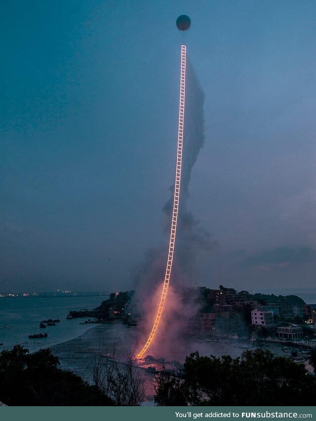 A Chinese artist created a 1,650-foot fireworks ladder in the sky, honoring his