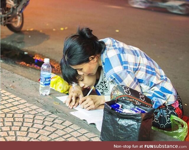 Poor Mother teaches her Son how to write letters (A street in Vietnam)