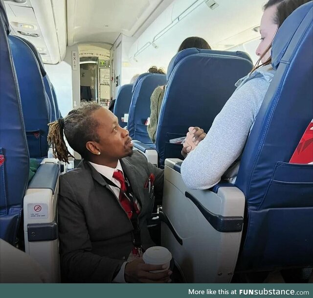 Flight attendant sits on the floor the entire flight to comfort distressed passenger