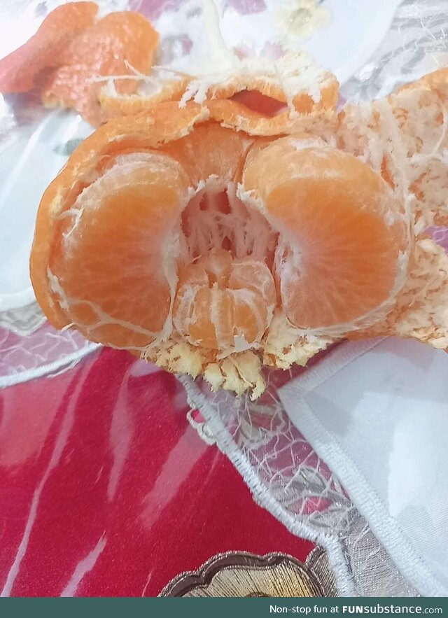 A small tangerine inside another tangerine