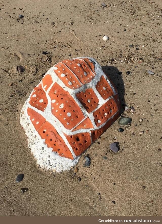 Part of a brick wall fell into the ocean and a piece eroded in the waves