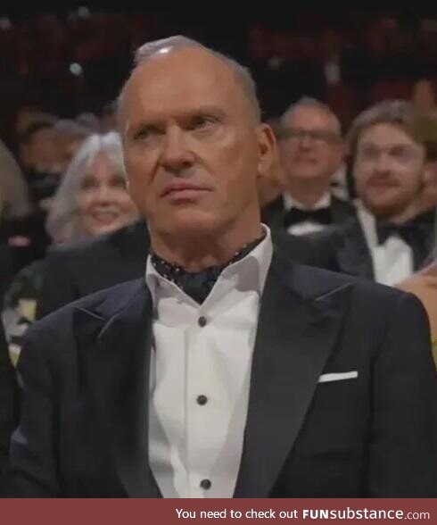 Michael Keaton at 2024 Oscars watches presentation by Danny DeVito and Arnold