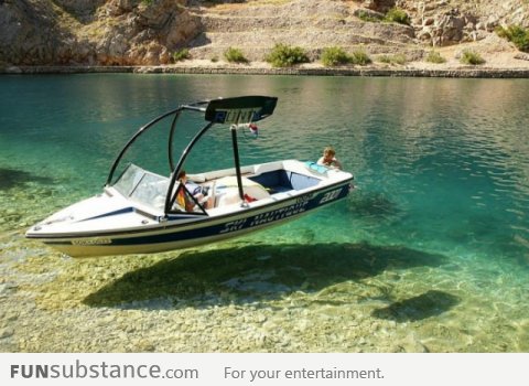 The water is so clear that the boat looks like hovering