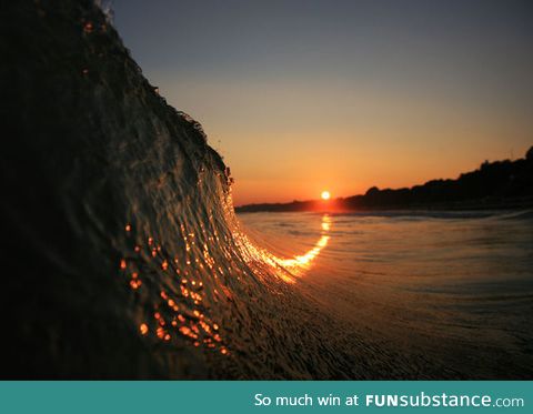The sunset curving up a wave