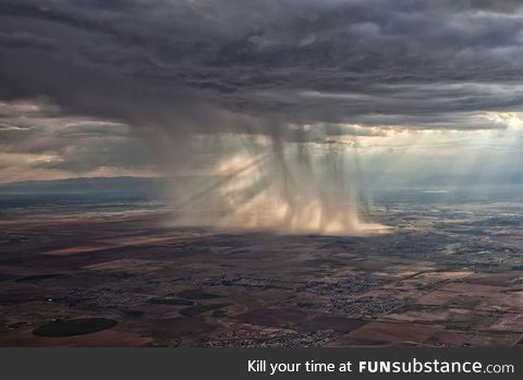 Distant storm cloud seen from airplane window