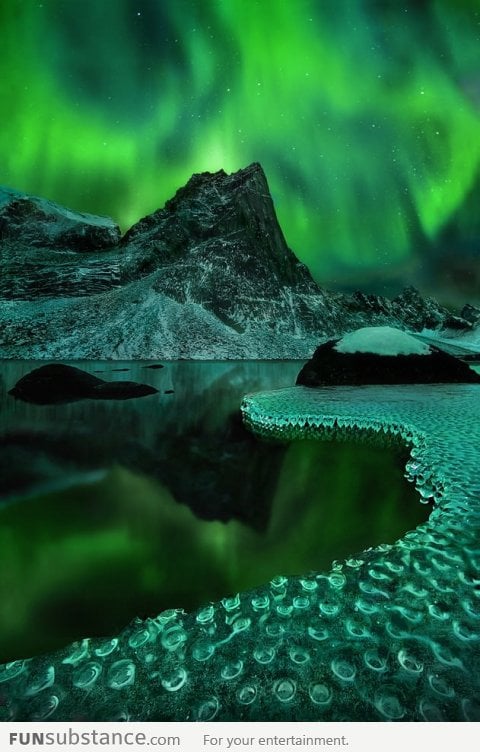 Spectacular view of Aurora Borealis reflected on frozen icicles