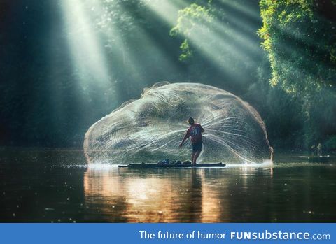 Fisherman casting his net