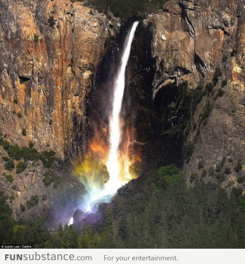 Waterfall in Yosemite National Park forms a rainbow