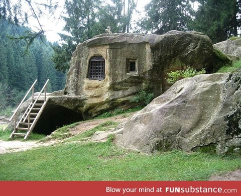 House carved into a stone by a 15th century Romanian monk