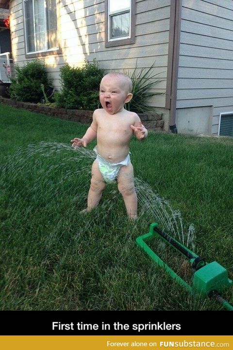 Baby meets sprinklers