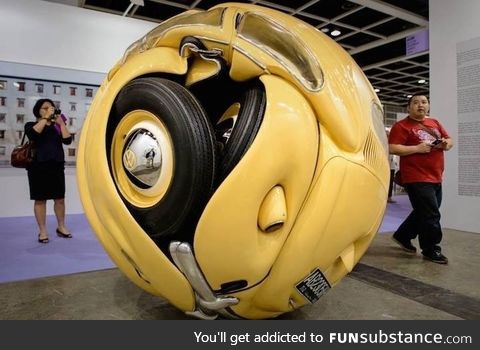 A Volkswagen Beetle compressed into a ball. From artist Ichwan Noor