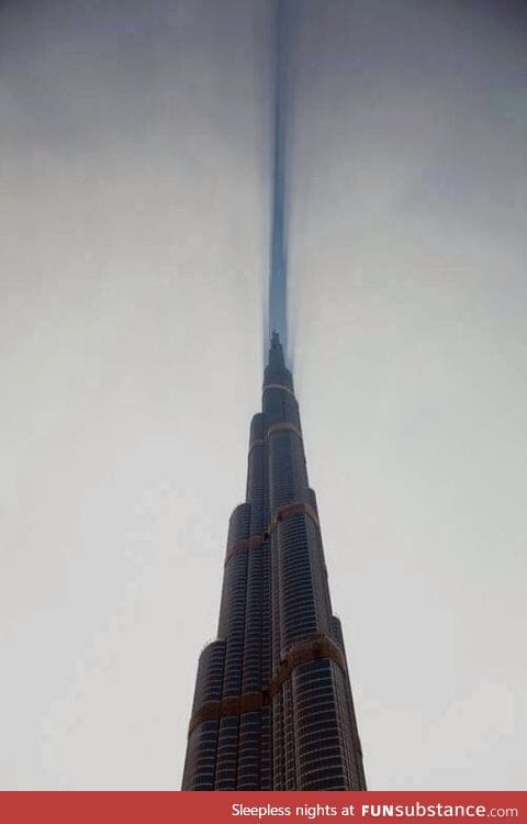 Cloud cut in half by Burj Khalifa