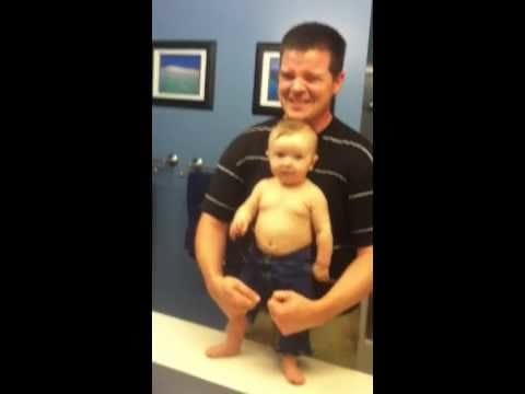 Cute baby shows off his little muscles with his dad