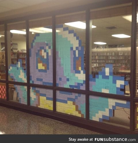 My school library likes to make Post-it note art. This is their latest creation