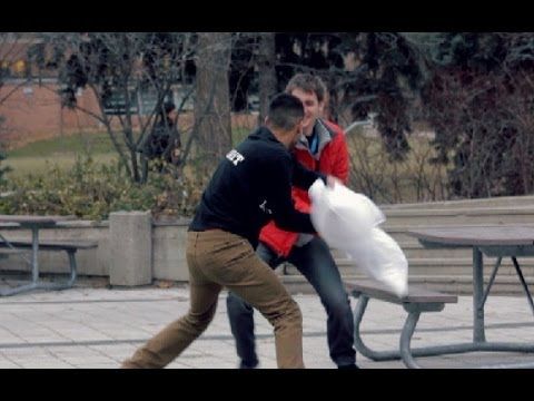 Guy gives random students pillows for a pillow fight