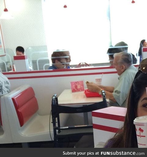 Old man eating by himself at In N Out with a picture of his wife