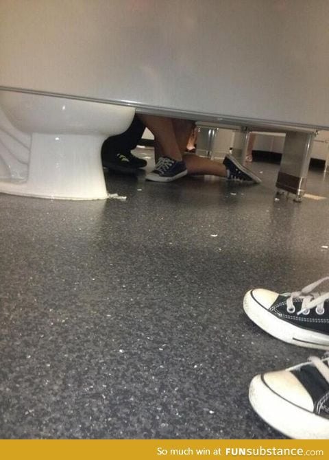 A woman proposing to a guy in a bathroom, aww