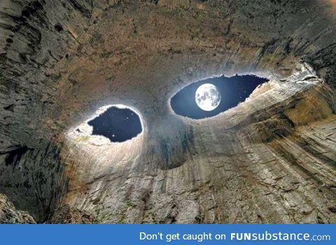 View of the moon from inside a cave