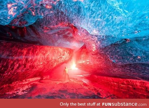 An Icelandic ice cave, lit up by a burning flare -- photo by Brynjar Ágústsson