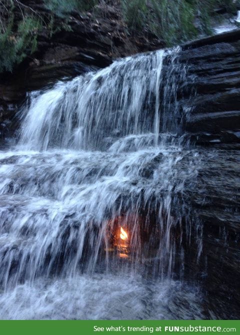 Eternal flame. This natural methane vent creates a flame under a waterfall