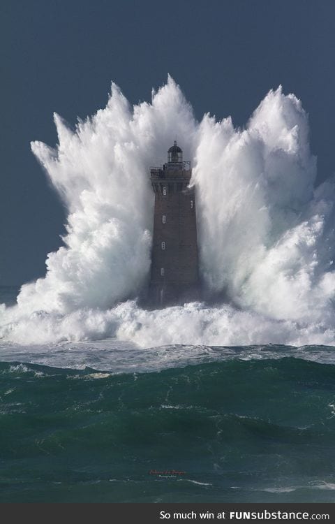 Wave bigger than the lighthouse it's hitting