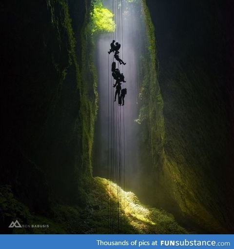 A team of explorers abseils 100m down into the magical Lost World Cave in New Zealand