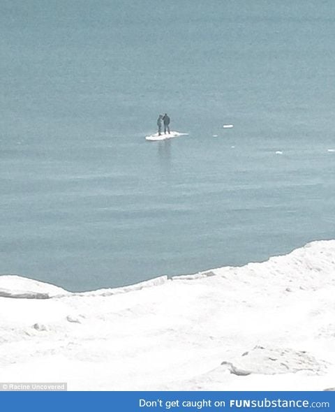 Teenagers floating away on a tiny iceberg on Lake Michigan