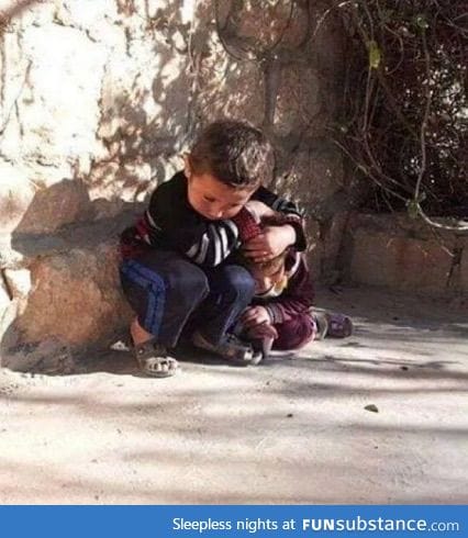 Feels!: Syrian boy protecting little sister from bombing: a true example of love