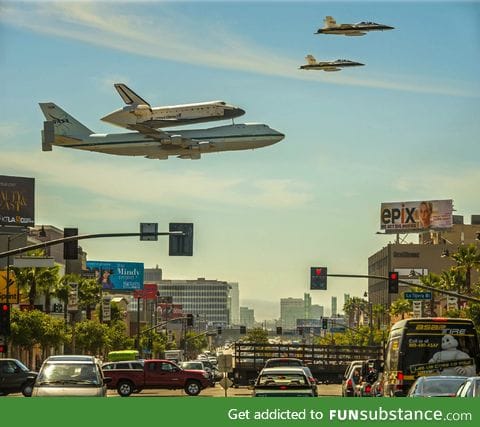 The space shuttle being carried by a 747 and escorted by two F-18's