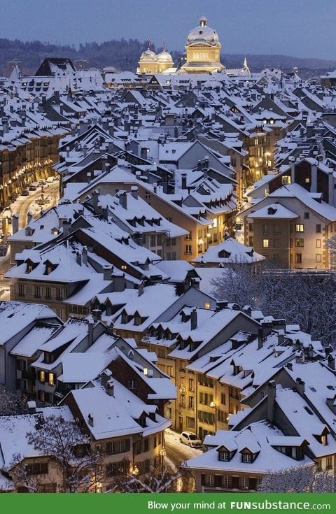 Snowy rooftops and well lit streets in Bern, Switzerland. Beautiful
