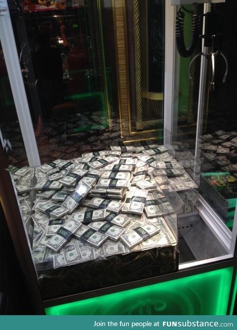 The prizes in this claw machine are stacks of $100