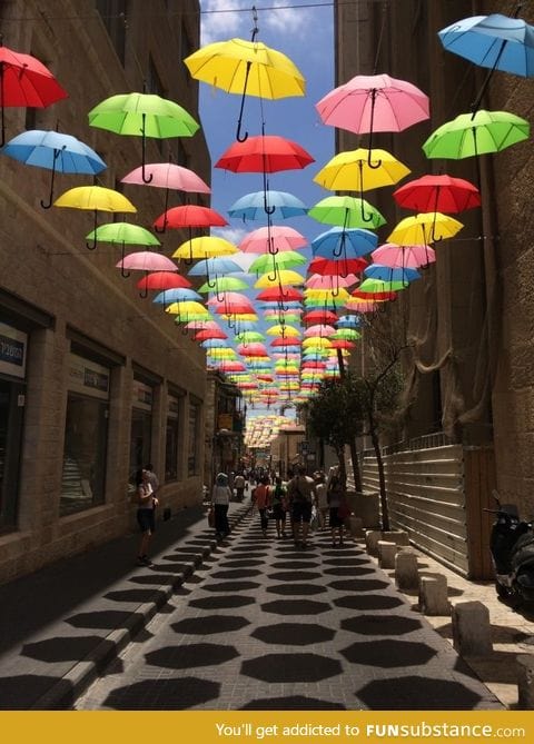 Umbrellas suspended over a side street in Jerusalem