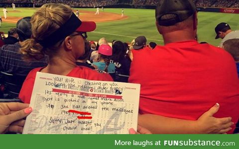 Person notices a wife sexting with another man at a ball game. Hands husband warning note