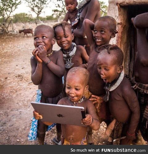 Tribal children see a ipad for the first time