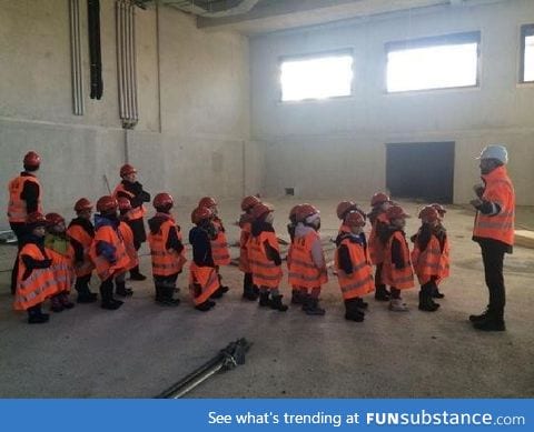 A bunch of kiddos getting a tour on a tech site