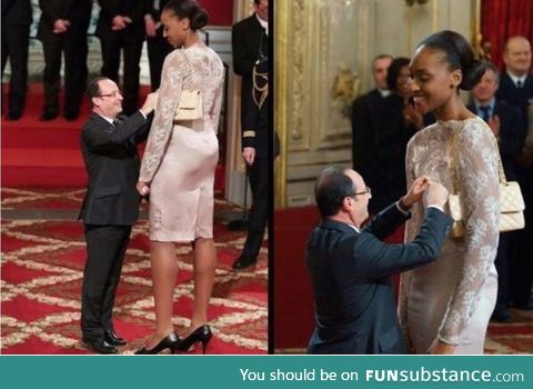 President Francois Hollande awards the basketball player Sandrine Gruda