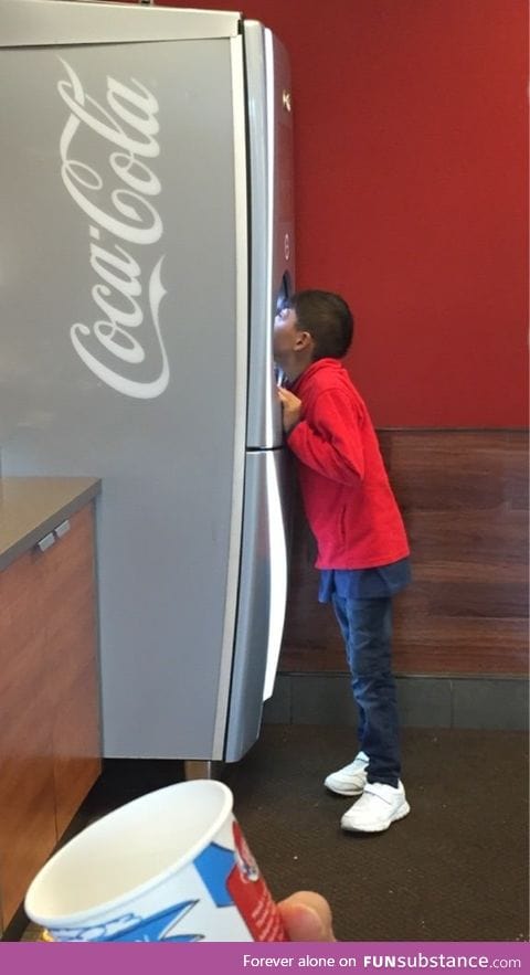 This kid was drinking soda straight from the dispenser