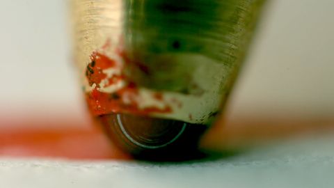 A closeup of how a ballpoint pen works