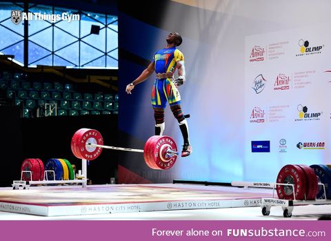 Weightlifter jumping up after a successful lift