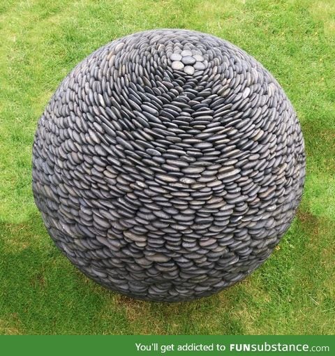 Sphere-shaped sculpture made of pebbles