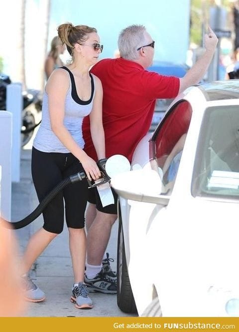 Jennifer Lawrence pumping gas while her dad salutes the paparazzi