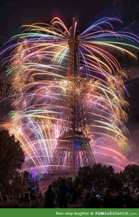 The Eiffel Tower smothered by fireworks on Bastille Day