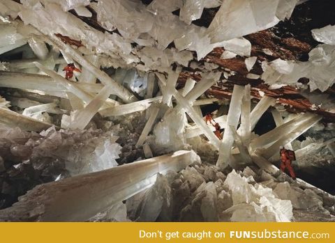 Scientists climbing over the world's largest natural crystals