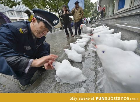 Chinese security guard has fun at work after a heavy snowfall