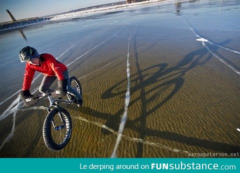 Winter cycling on crystal clear frozen Lake Michigan