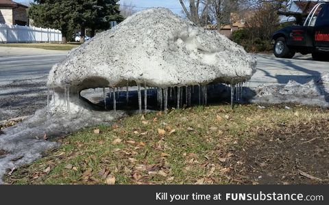This pile of snow is melting out from under itself