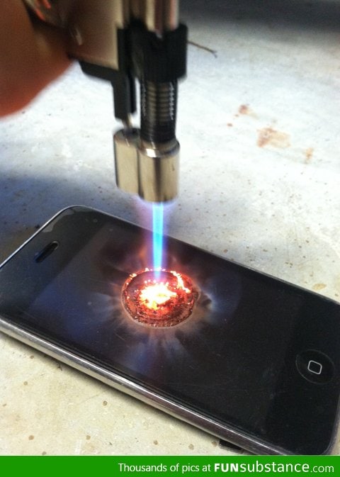 An iPhone being burned with a butane lighter